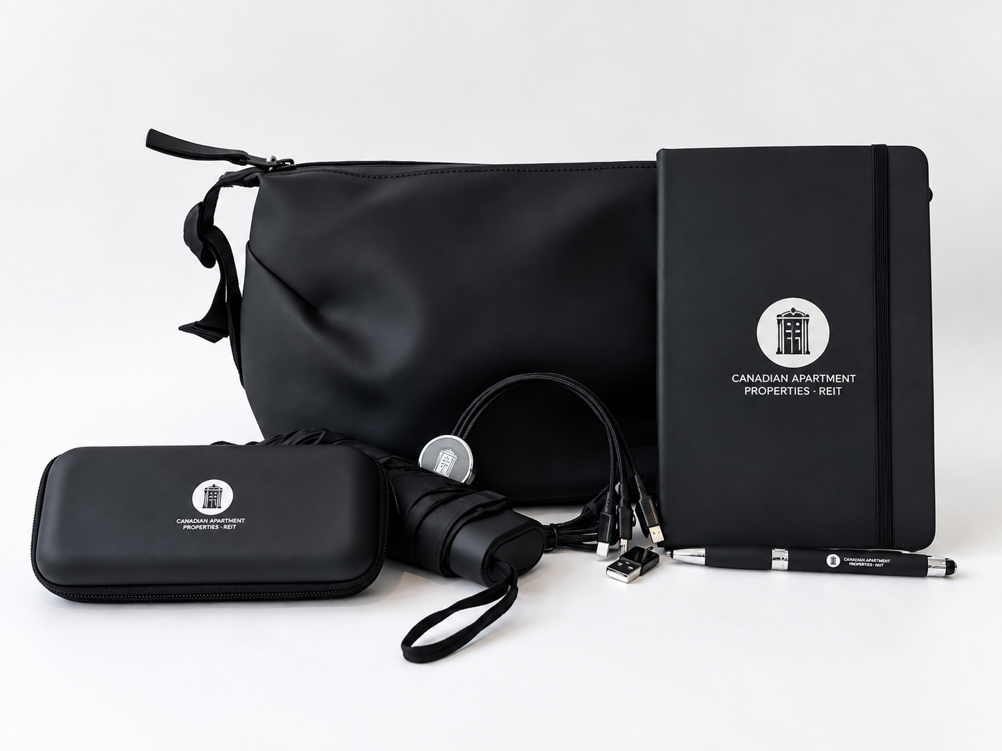 Premium branded corporate gift set with notebook, tech accessories, travel pouch and pen, created as a polished employee and client gifting solution.