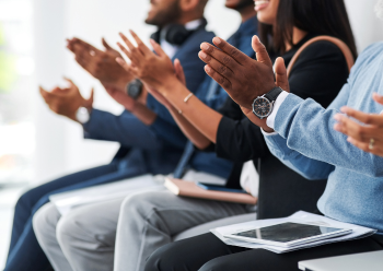 Employees clapping hands in celebration.